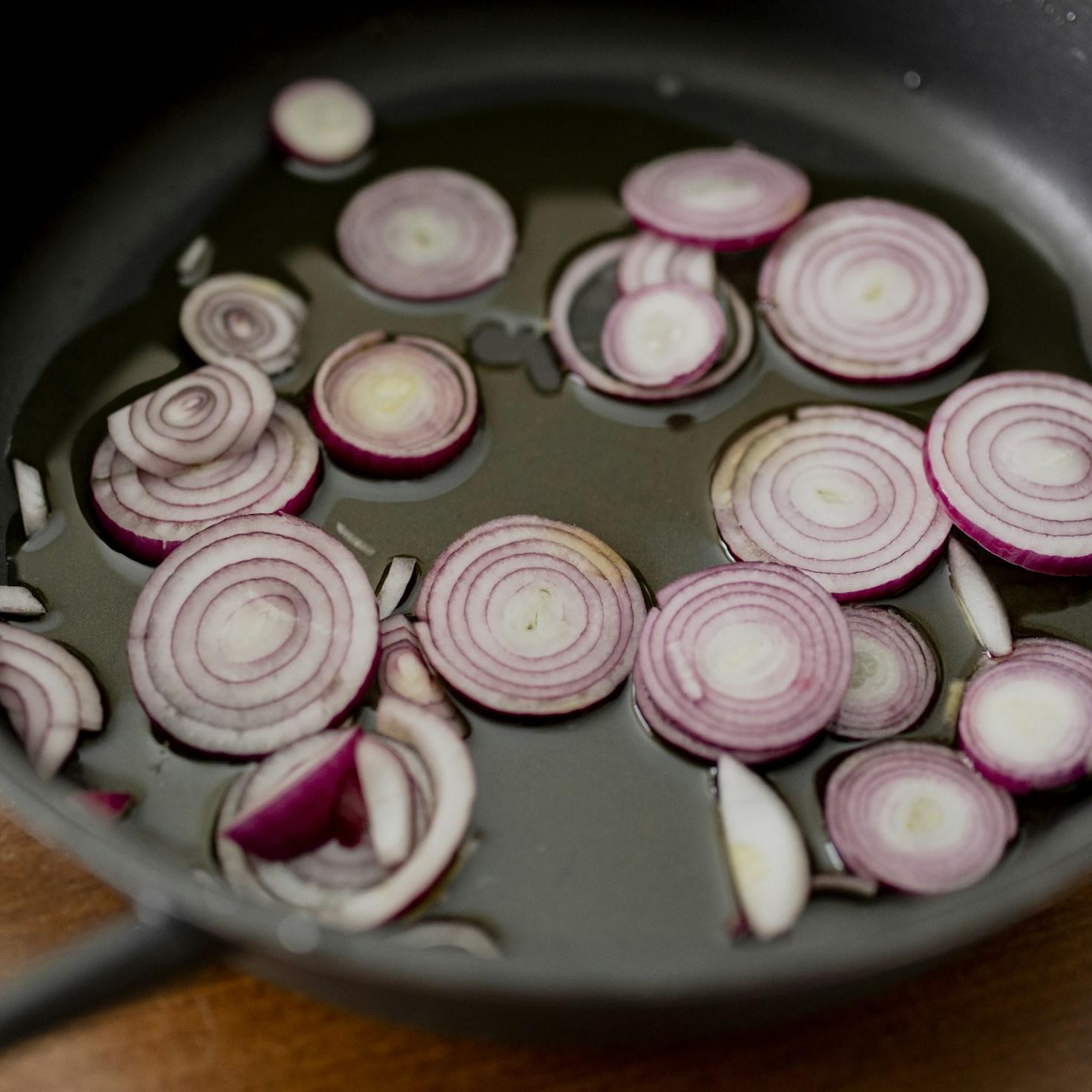 Community members collaborating in a modern kitchen space, sharing recipes and cooking techniques